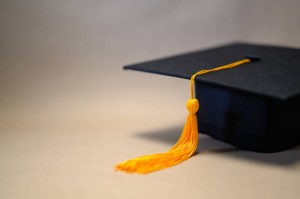 Black Graduation Hat placed on brown paper